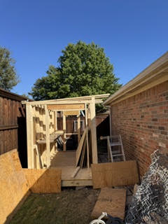 Shed frame under construction in a backyard